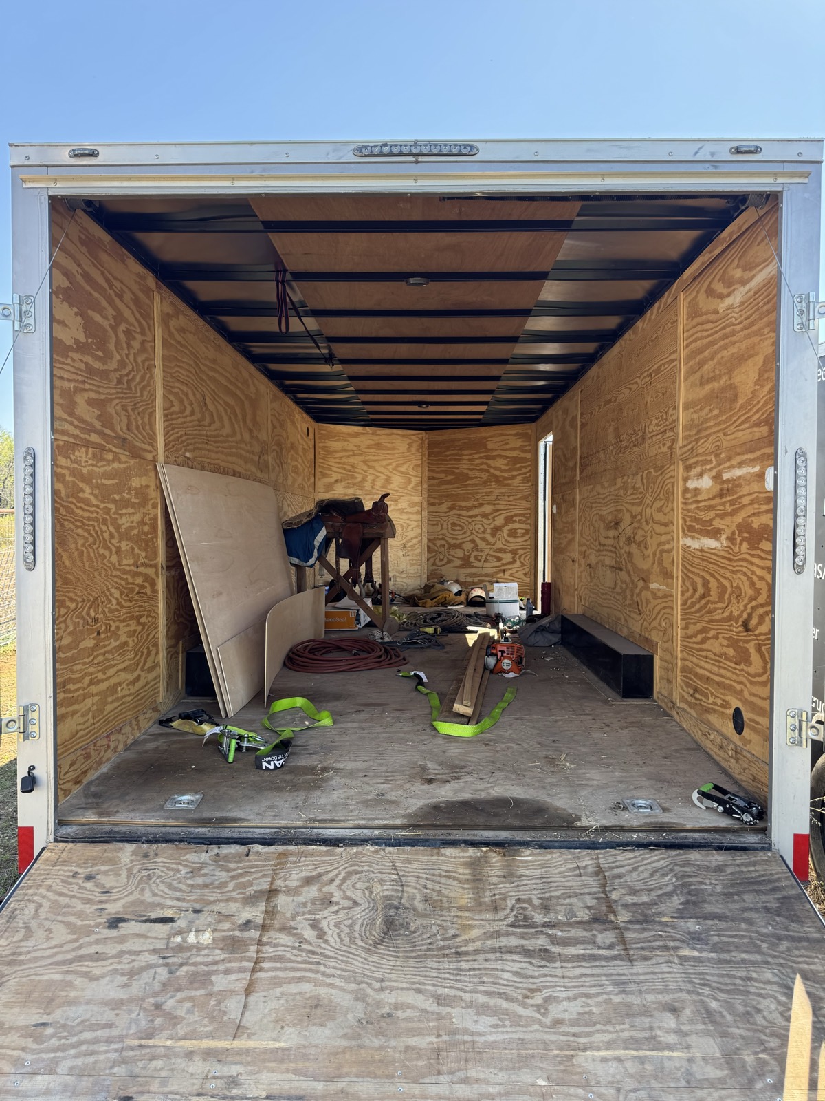 Inside the enclosed trailer: plywood walls and floor