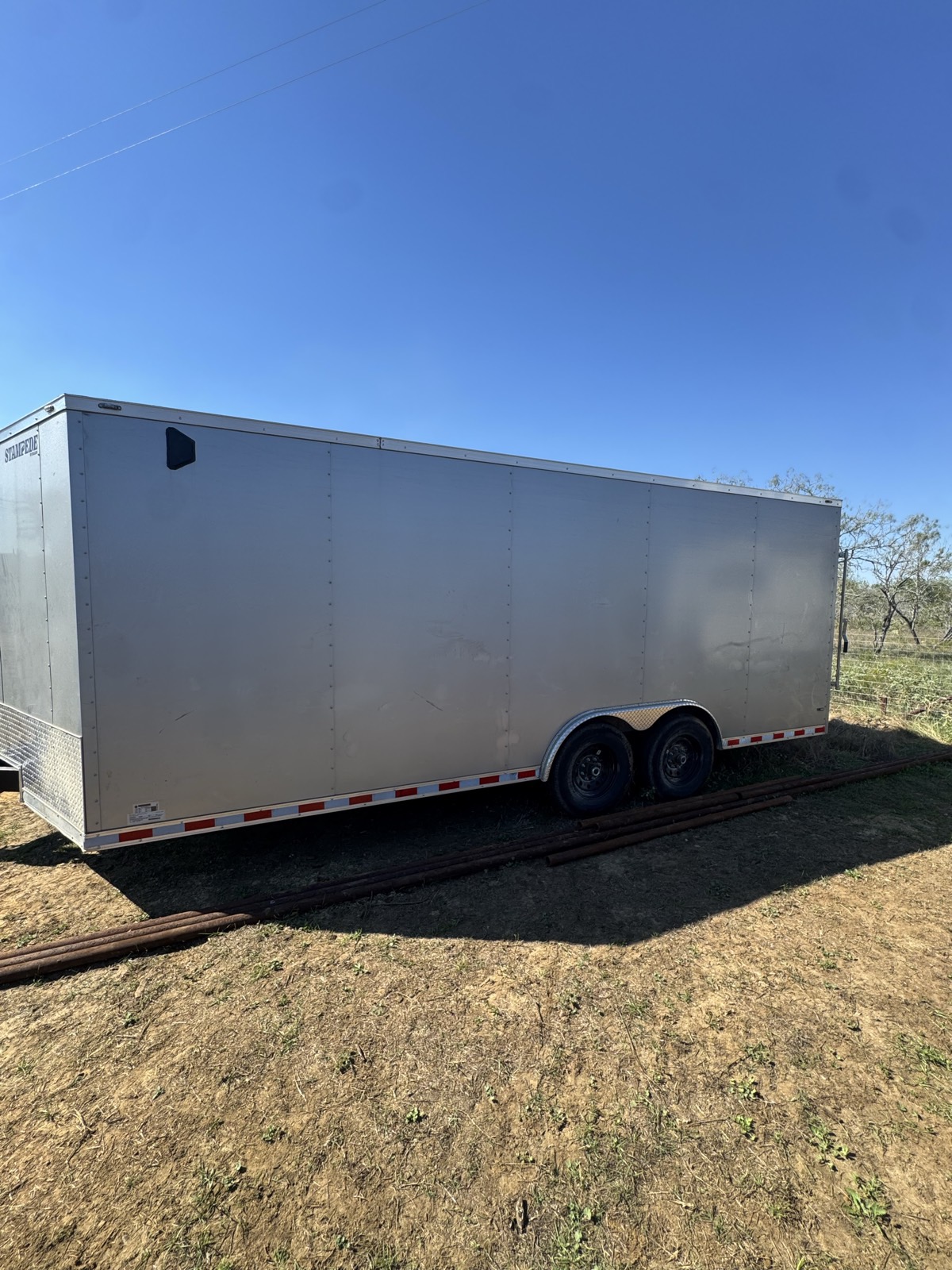 Silver 20 foot Stampede enclosed trailer with tandem axles